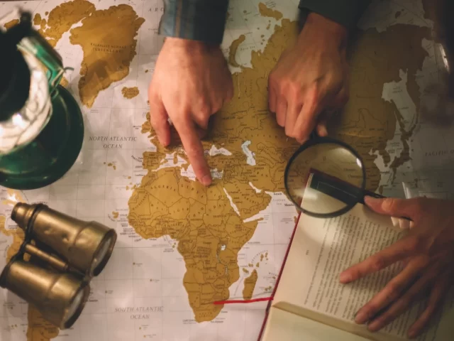crop-hands-with-magnifying-glass-map