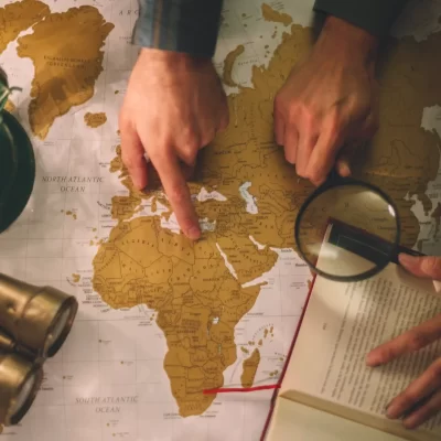 crop-hands-with-magnifying-glass-map